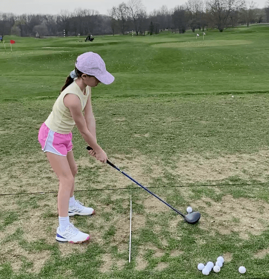 Golfer at the top of a full swing